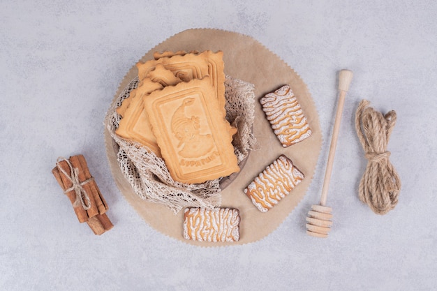 Bunch of various biscuits and cinnamon sticks on gray background. High quality photo