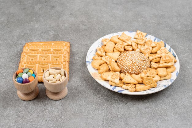 Bunch of various delicious biscuits and candies on marble surface