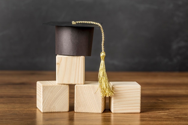 Bunch of wooden cubes with graduation cap