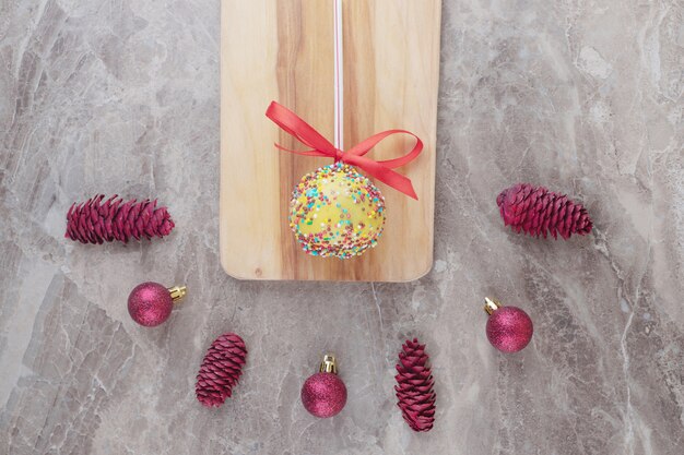 Bundle of christmas decorations and a lollipop on marble