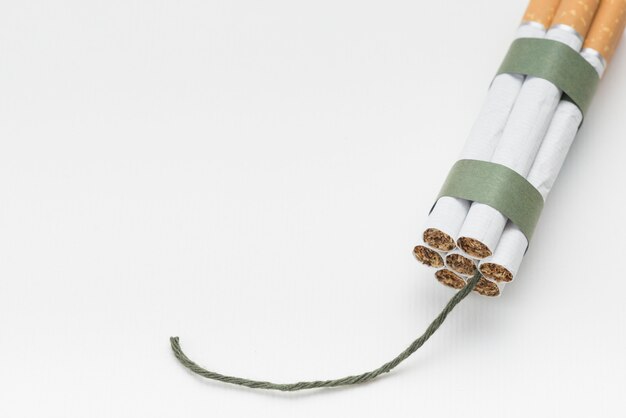 Bundle of cigarette with wick on white backdrop