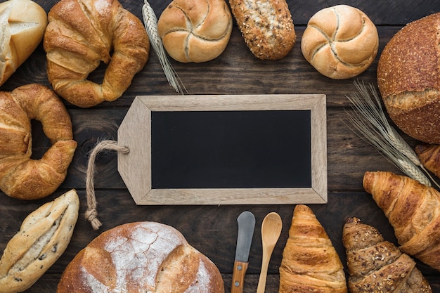 Free photo buns and wheat around blackboard