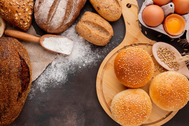 Buns with sesame seeds and wooden spoon