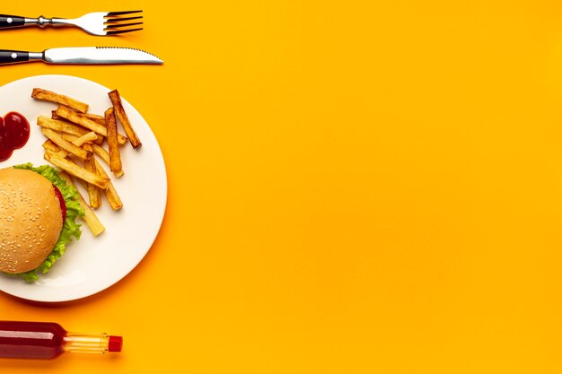 Burger and french fries on plate with copy space