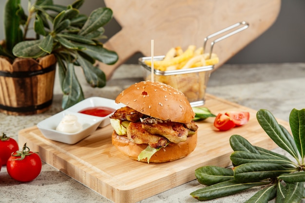 Burger served with french fries ketchup and mayonnaise