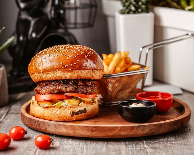 Burger with fries and cherry tomatoes