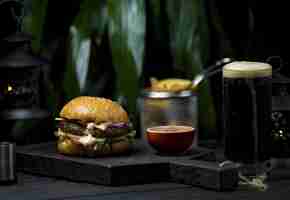 Free photo burger with melter cheese and steak in a dark space