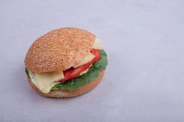 Burger with omelet, tomatoes, mushrooms and onion.