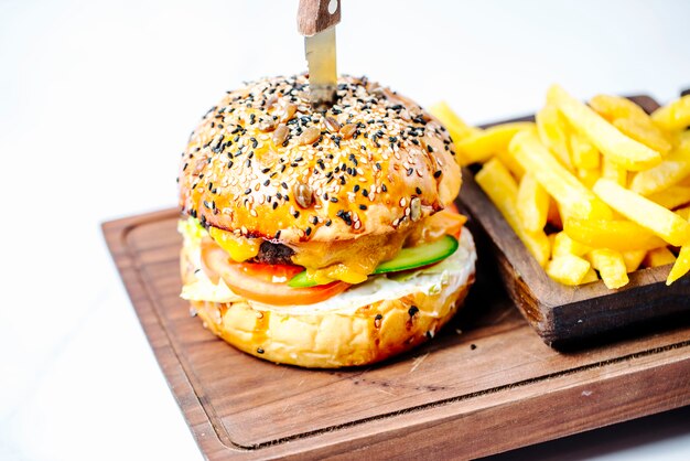 Burger with sesame bun and fries