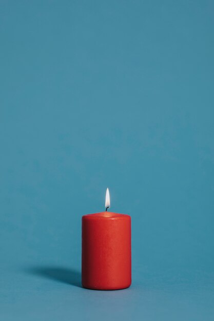 Burning candle in red color