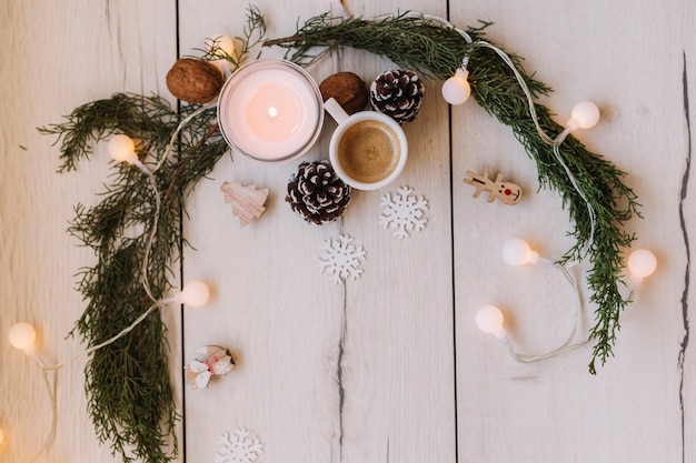 Free photo burning candle with branches on table