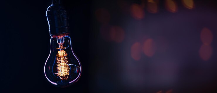 Free Photo a burning lamp hangs in the dark on a blurred background space for text