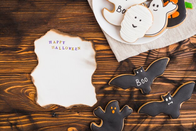 Burning paper near Halloween gingerbread on plate