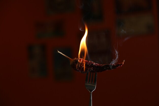 Free photo burning red pepper on the fork