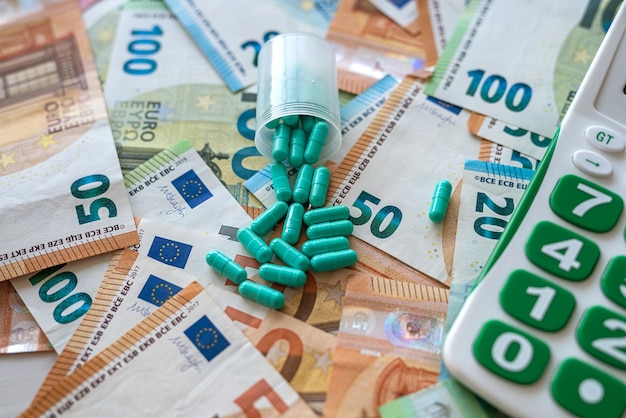Business calculator pharmacy pills and euro banknotes Premium Photo