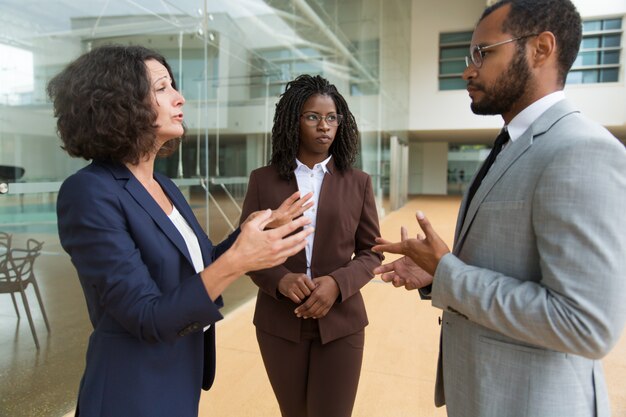 Business colleagues discussing project near office building