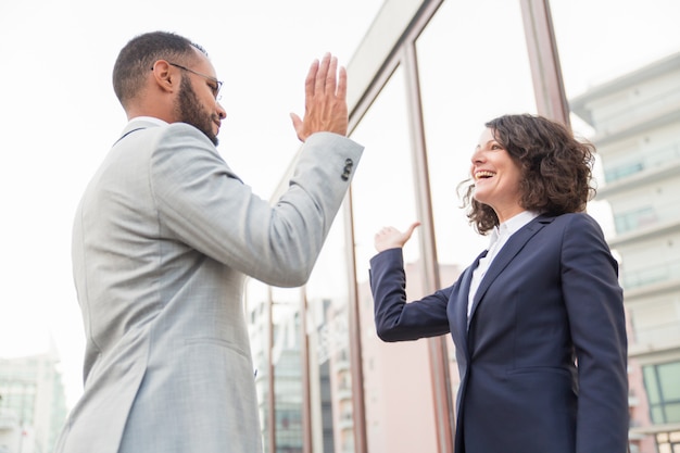 Business colleagues giving high five