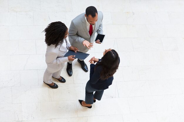 Business colleagues meeting in hall and discussing project