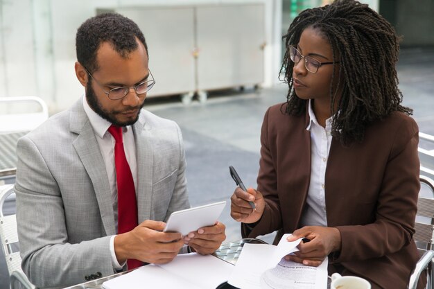 Business colleagues studying reports