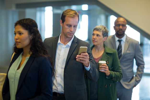 Business commuters waiting in queue