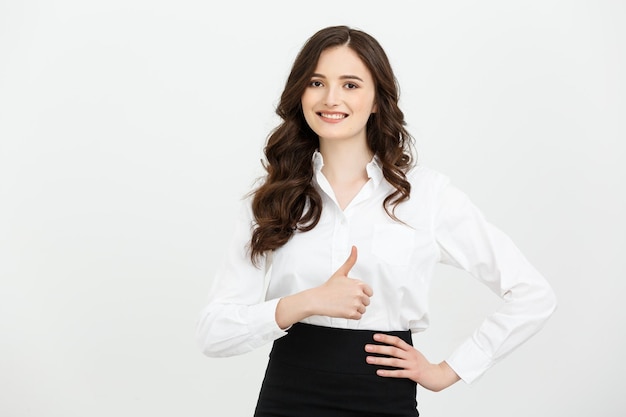 Business concept confident young cheerful woman showing thumb up isolated over grey copy space backg
