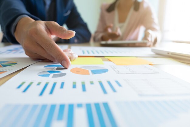 Business concept discussing graphs showing the results of their