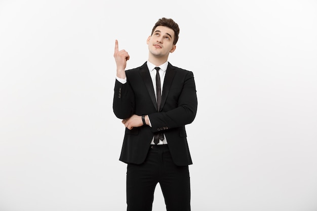 Business Concept: Handsome businessman with a finger pointed up isolated over white background