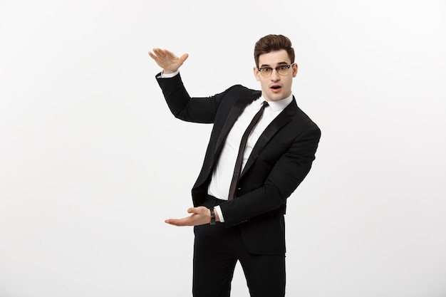 Business Concept - Handsome young business man happy smile, businessman showing something on the open palm, concept of advertisement product isolated over white background