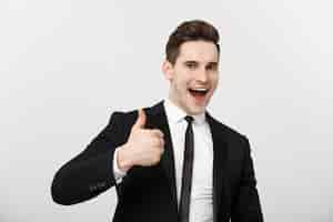 Free photo business concept portrait of excited man with opened mouth dressed in formal wear giving thumbsup ag...