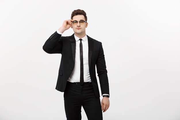 Business Concept: Portrait handsome young businessman wearing glasses isolated over white background