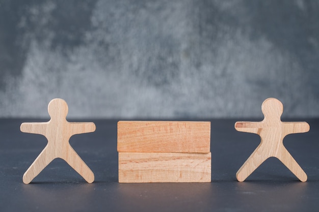 Business concept with wooden blocks column with wooden human figure.