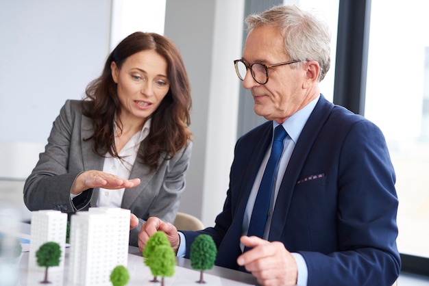 Business couple over architectural model