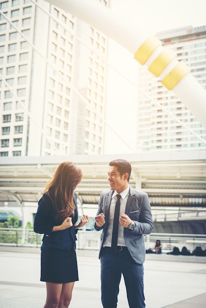 Business couple hands up doing yes outdoor. Concept of teamwork