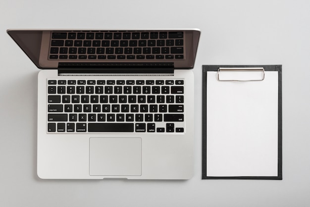 Business elements composition with clipboard and laptop