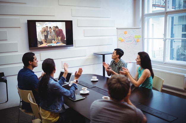 Business executive applauding during a video conference