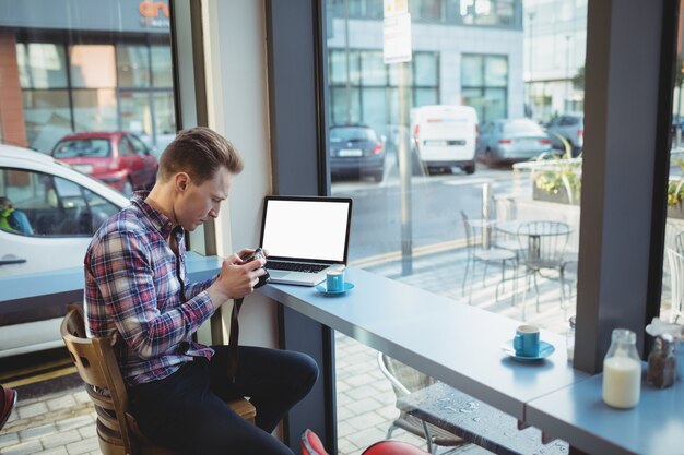 Business executive looking at pictures in camera