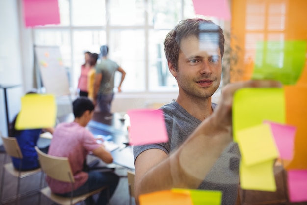 Business executive reading sticky notes