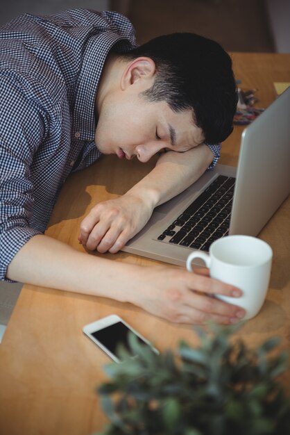 Business executive sleeping at his desk