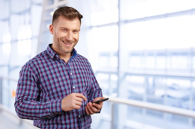 Business executive texting on his cell phone