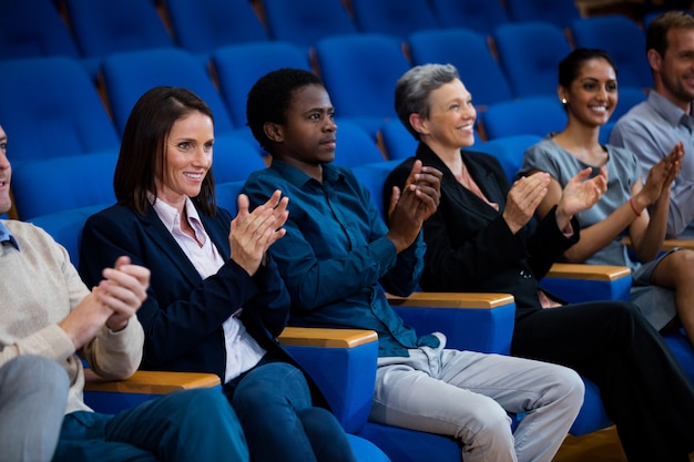 Business executives applauding in a business meeting