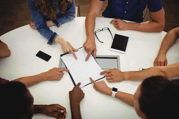 Business executives pointing on clipboard