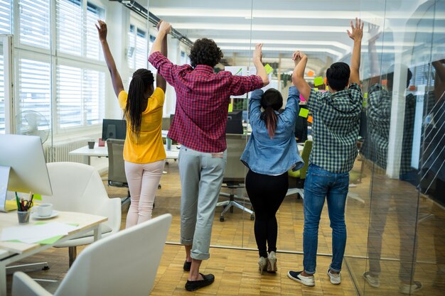 Business executives raising arms