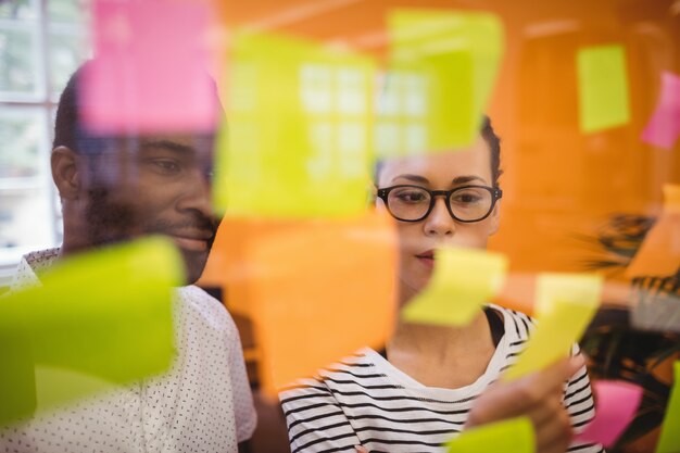 Business executives reading sticky notes