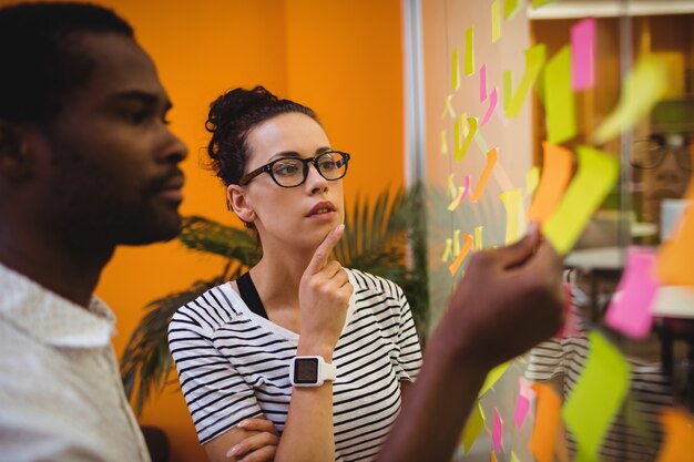 Business executives reading sticky notes