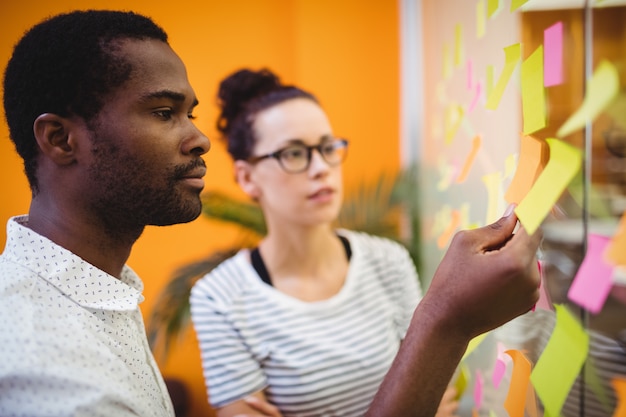 Free photo business executives reading sticky notes