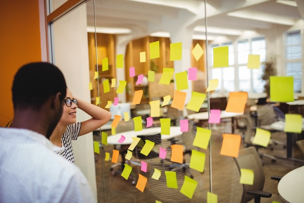 Free photo business executives reading sticky notes