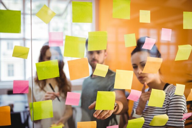 Business executives reading sticky notes