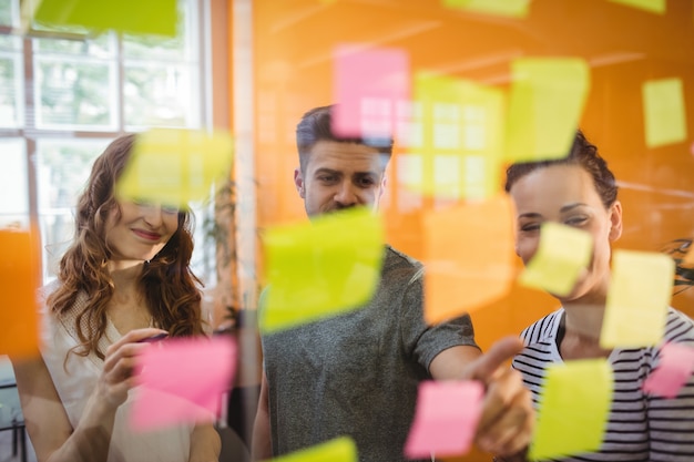 Business executives reading sticky notes