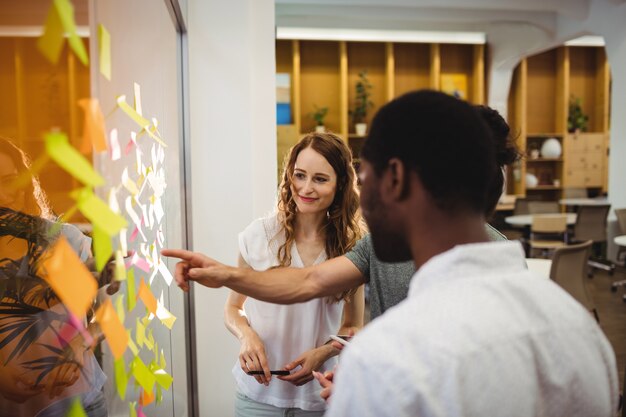 Business executives reading sticky notes