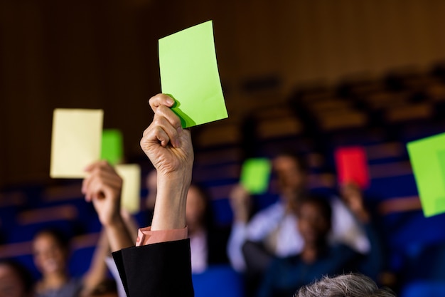 business executives show their approval by raising hands